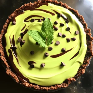 - 1 pre-made chocolate graham cracker pie crust - 1 cup heavy whipping cream - 1/2 cup powdered sugar - 1 teaspoon peppermint extract - 1 cup semi-sweet chocolate chips - 3 tablespoons unsalted butter - 3 tablespoons green food coloring - 1/4 cup mini chocolate chips (for garnish) - Fresh mint leaves (for garnish) This pie brings together rich chocolate and fresh mint. Each ingredient plays a key role. The chocolate graham cracker crust gives a sweet crunch. Heavy cream makes the filling light and fluffy. Powdered sugar adds sweetness. Peppermint extract gives that fresh minty taste. Semi-sweet chocolate chips create a rich chocolate flavor. Unsalted butter helps smooth the chocolate mixture. Green food coloring makes it look fun and festive. Lastly, mini chocolate chips and fresh mint leaves add a nice touch for garnish. I love how easy this recipe is. You can find most of these ingredients at any grocery store. Make sure to use fresh mint leaves. They add a nice flavor and look great on top. This pie is perfect for parties or just a sweet treat at home. Enjoy every bite of this mint chocolate grasshopper pie. It’s a dessert everyone will adore! - Combine 1 cup of semi-sweet chocolate chips and 3 tablespoons of unsalted butter in a microwave-safe bowl. - Melt the mixture in the microwave, heating for 30 seconds at a time. Stir after each interval until it is smooth. Let it cool slightly before using. - In a large mixing bowl, whip 1 cup of heavy whipping cream using an electric mixer on medium speed. Stop when you see soft peaks form. - Gradually add 1/2 cup of powdered sugar. Keep whipping until you see stiff peaks. Then, mix in 1 teaspoon of peppermint extract for that fresh mint flavor. - Gently fold the cooled chocolate mixture into the whipped cream. Keep mixing until it is fully combined and smooth. - Add 3 tablespoons of green food coloring a few drops at a time. Mix until you get that bright minty color you love. - Pour the mint chocolate filling into the pre-made chocolate graham cracker pie crust. Use a spatula to smooth the top. This pie is easy to make and so delicious! Enjoy the process. To make great whipped cream, use cold equipment. This includes your bowl and beaters. Cold tools help the cream whip faster and become fluffier. For stiff peaks, whip the cream until it holds its shape. This means turning off the mixer and checking the cream. If it stands tall, you’re ready! If not, keep whipping. Getting the right green color is key. Start with a few drops of food coloring. Mix it in and check the shade. You can always add more if needed. If you want a natural option, use spinach juice or matcha powder. Both can give a lovely green hue without artificial colors. Presentation matters! Serve the pie on a bright plate. This makes the colors pop. For a fun touch, add a drizzle of chocolate sauce on the plate. Pair it with milk or a minty drink like mojito. This adds a refreshing taste that complements the pie. Enjoy your creation with friends and family! {{image_2}} You can make your Mint Chocolate Grasshopper Pie even more exciting. One way is to add a layer of mint chocolate ganache. To do this, melt semi-sweet chocolate chips with a bit of cream. Pour this mixture over the filling before chilling the pie. This adds a rich layer that enhances the chocolate flavor. Another fun twist is to incorporate crushed peppermint candies. Simply sprinkle them over the top of the pie before chilling. This not only adds a nice crunch but also boosts the mint flavor. You can even mix some crushed candies into the filling for extra surprises with each bite. If you need gluten-free options, choose a gluten-free chocolate graham cracker crust. Many brands offer this, and it works great for our pie. Check the labels to ensure they fit your needs. For a vegan adaptation, swap the heavy cream with coconut cream. Use dairy-free chocolate chips instead of semi-sweet ones. Make sure the pie crust is vegan as well. These simple changes let everyone enjoy this treat without missing out. To keep your Mint Chocolate Grasshopper Pie fresh, you should store it in the fridge. First, cover the pie tightly with plastic wrap. This keeps out air and moisture. You can also use a pie container if you have one. The pie stays fresh for about 3 to 5 days. After that, the texture may change, and it won't taste as great. If you want to save some pie for later, freezing is a good option. Follow these steps: 1. Wrap the Pie: First, make sure the pie is fully set in the fridge. Then, wrap it tightly in plastic wrap. You can also use aluminum foil for extra protection. 2. Store in a Container: Place the wrapped pie in a freezer-safe container or a zip-top bag. This helps prevent freezer burn. 3. Label and Date: Write the date on the container or bag. This way, you know how long it's been in the freezer. To thaw the pie, take it out of the freezer and place it in the fridge for several hours or overnight. This slow thawing keeps the texture smooth. You can also leave it at room temperature for about 30 minutes if you're in a hurry. Just remember, once thawed, eat the pie within 2 days for the best taste. Mint Chocolate Grasshopper Pie is a cool and creamy dessert. It combines mint and chocolate flavors for a sweet treat. The pie has a chocolate graham cracker crust and a fluffy mint filling. You can serve it chilled, making it perfect for warm days. Yes, you can use a homemade pie crust! To make your own crust, crush chocolate graham crackers into fine crumbs. Mix them with melted butter and press the mixture into a pie dish. Bake it for about 10 minutes at 350°F to set. This gives a fresh taste and a nice crunch. You can prepare this pie a day in advance. Make the filling and fill the crust as normal. Cover the pie well and place it in the fridge. This allows the flavors to blend and makes it easier for you on the day of serving. Just remember to add the garnishes right before serving! This blog post shared how to make a Mint Chocolate Grasshopper Pie. We covered the list of tasty ingredients and provided step-by-step instructions for each part. You learned tips for perfecting the whipped cream and ideas for fun variations. We also explored storage options to keep your pie fresh. Now, you can impress friends and family with this vibrant treat. Enjoy making this pie and feel proud of your baking skills!