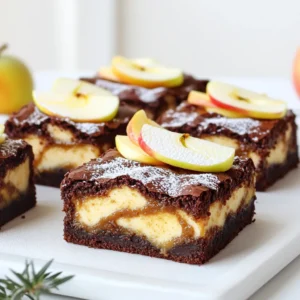 - 1 cup unsalted butter, melted - 1 ½ cups granulated sugar - 1 teaspoon vanilla extract - 4 large eggs - 1 cup all-purpose flour - ½ cup unsweetened cocoa powder - ½ teaspoon baking powder - ¼ teaspoon salt - 1 cup apple butter - 8 oz cream cheese, softened - ½ cup powdered sugar - 1 teaspoon cinnamon - 1 teaspoon lemon juice For this recipe, you need precise measurements for the best results. You can swap unsalted butter with coconut oil if you want a dairy-free option. If you prefer a lower sugar option, consider using a sugar substitute that measures like sugar. You can replace cream cheese with mascarpone cheese for a richer flavor. Fresh apple butter makes a big difference in flavor. You can make your own by slow-cooking peeled apples with sugar, spices, and a bit of lemon juice until soft. Puree this mix until smooth. Store it in jars and refrigerate for up to two weeks. You can also find fresh apple butter at farmers' markets or specialty stores. Always check the label for no added sugars or preservatives for the best taste. First, preheat your oven to 350°F (175°C). Grab a 9x13 inch baking pan. Grease it well with butter. Then, line the bottom with parchment paper. Leave some paper hanging over the edges. This will help you lift the brownies out later. In a large bowl, pour in the melted butter. Add the granulated sugar. Whisk them together until they mix well. Next, add the vanilla extract. Crack in four eggs, one at a time. Mix well after each egg. In another bowl, sift the flour, cocoa powder, baking powder, and salt. Slowly add this dry mix to the wet mix. Stir until everything is just combined. Now, let’s make the cheesecake layer. Take another bowl and add the softened cream cheese. Beat it with a mixer until it is smooth. Next, add the powdered sugar, cinnamon, and lemon juice. Mix until creamy. Then, stir in the apple butter. Make sure it is well combined and smooth. Pour half of the brownie batter into the prepared pan. Spread it evenly across the bottom. Now, take the apple butter cheesecake mixture and spread it over the brownie layer. Use a spoon to dollop the remaining brownie batter on top. Take a knife or spatula and swirl the layers together. This creates a nice marbled effect. Place the pan in the oven and bake for 30 to 35 minutes. Check if they are done by inserting a toothpick in the center. It should come out with a few moist crumbs, not wet batter. Once baked, let the brownies cool completely in the pan. After cooling, lift them out using the parchment paper. Cut them into squares and enjoy! To make the best brownies, focus on mixing. Do not overmix your batter; just stir until combined. This keeps the texture nice and fudgy. Use room temperature eggs for a smoother mix. Also, be sure to preheat your oven to 350°F (175°C). This step is key for even baking. Use a 9x13 inch baking pan for these brownies. Line it with parchment paper for easy removal. A whisk is great for mixing your wet ingredients. Use a sifter for the dry mix to avoid lumps. A rubber spatula helps incorporate everything smoothly. Lastly, a toothpick is your best friend for checking doneness. One common mistake is baking too long. Check your brownies a few minutes early. If your toothpick comes out with moist crumbs, they’re done. Another mistake is not cooling them properly. Let the brownies cool in the pan before cutting. This helps them set and makes cutting easier. Lastly, don’t skip the apple butter in the cheesecake layer; it adds flavor and moisture. {{image_2}} You can have fun with your Apple Butter Cheesecake Brownies. Adding chocolate chips gives a rich twist. Use semi-sweet or dark chocolate chips for a deeper flavor. You can also add nuts for crunch. Chopped walnuts or pecans work well. They add texture and flavor. Mix them into the brownie batter or sprinkle on top before baking. Each bite will surprise you with a new taste. Want a gluten-free version? No problem! You can swap the all-purpose flour for a gluten-free blend. Many brands make great flour mixes that work well in brownies. Just make sure it has a good binding agent. This keeps your brownies moist. Follow the same steps in the recipe, and you will enjoy a delicious treat without gluten. For a vegan option, we can make some easy swaps. Replace the butter with coconut oil or vegan butter. Use flax eggs instead of real eggs. To make a flax egg, mix one tablespoon of ground flaxseed with three tablespoons of water. Let it sit for a few minutes until it thickens. For the cream cheese, you can use a vegan cream cheese substitute. Follow the same recipe, and you’ll have tasty vegan brownies everyone can enjoy. To keep your Apple Butter Cheesecake Brownies fresh, store them in an airtight container. This helps prevent them from drying out. You can keep them at room temperature for up to three days. If you want them to last longer, store them in the fridge. They can stay fresh for about a week when chilled. Freezing these brownies is easy and great for later. First, let them cool completely. Then, cut them into squares. Wrap each square tightly in plastic wrap. Place the wrapped brownies in a freezer-safe bag or container. You can freeze them for up to three months. When you want to enjoy them, let them thaw in the fridge overnight. To enjoy your brownies warm, remove them from the fridge or freezer. If they are frozen, let them thaw first. Preheat your oven to 350°F (175°C). Place the brownies in a baking dish. Heat them for about 10-15 minutes. This will make them soft and gooey again. You can also microwave them for 15-20 seconds if you're in a hurry. Enjoy the warm taste of apple butter and cheesecake! You can use mascarpone cheese or Greek yogurt. Both options work well. Mascarpone gives a rich taste. Greek yogurt adds a tangy flavor. You can also try silken tofu for a dairy-free option. To check if the brownies are done, insert a toothpick in the center. If it comes out with a few moist crumbs, they are ready. If it comes out wet, they need more time. Keep an eye on them, as baking times can vary. Yes, homemade apple butter is a great choice! It adds a personal touch to your brownies. Just make sure it is smooth and well-blended. This will ensure a nice texture in your cheesecake layer. These brownies stay fresh for about 4 to 5 days. Store them in an airtight container. For longer storage, you can freeze them. They last up to three months in the freezer. Just thaw them in the fridge before serving. This blog post covered how to make delicious Apple Butter Cheesecake Brownies. I shared the key ingredients, their measurements, and helpful tips for freshness. You learned step-by-step how to prepare and bake these treats. I also offered baking techniques and variations, plus storage advice to keep them fresh. Now, you can confidently create this delightful dessert. Enjoy your baking journey and impress everyone with your tasty results.