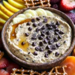 To make the High-Protein Chocolate Chip Cookie Dough Dip, you'll need these simple ingredients: - 1 cup chickpeas, drained and rinsed - 1/4 cup almond butter - 1/4 cup maple syrup - 2 teaspoons vanilla extract - 1/2 teaspoon baking soda - 1/4 teaspoon sea salt - 1/3 cup mini chocolate chips - Optional: 1 tablespoon chia seeds for added texture and nutrition Each ingredient plays an important role in making this dip creamy, sweet, and delicious. Chickpeas give it a great base and boost protein. Almond butter adds healthy fats and a nice flavor. Maple syrup sweetens the mix naturally. Vanilla extract enhances the taste, while baking soda and sea salt balance everything out. Mini chocolate chips bring the classic cookie dough flavor, and chia seeds add extra nutrition if you want. You can mix and match these ingredients to find the perfect taste for you. - Step 1: Combine ingredients Start by placing the drained chickpeas, almond butter, maple syrup, vanilla extract, baking soda, and sea salt into a food processor. Make sure to measure each ingredient carefully. This mix is the base of your dip. - Step 2: Blend until smooth Now, blend the mixture until it becomes smooth and creamy. You may need to stop and scrape down the sides of the bowl. This ensures all the ingredients mix well. Take your time; a good blend gives the best texture. - Step 3: Fold in chocolate chips and chia seeds After blending, it’s time to add the mini chocolate chips. If you choose to use chia seeds for extra nutrition, fold them in now too. Stir gently so the chips and seeds are evenly spread throughout the dip. - Step 4: Taste and adjust sweetness Before you chill your dip, have a taste. If you feel it needs more sweetness, add a little more maple syrup. Remember, you can always add more, but you can't take it out! - Step 5: Chill before serving Finally, transfer your dip to a bowl and place it in the fridge. Let it chill for about 30 minutes, so it firms up slightly. Chilling enhances the flavors and makes it more enjoyable when you serve it. - Importance of ingredient quality: Always use fresh and high-quality ingredients. Fresh chickpeas make a big difference. They give a better texture and taste to your dip. Choose pure almond butter without additives. It helps keep the dip creamy and smooth. - Adjusting sweetness and texture: Taste your dip as you make it. If it’s not sweet enough for you, add more maple syrup. Start with a little. Blend well, then taste again. You can also add chia seeds for extra texture and nutrition. They give a nice crunch. - Blending techniques for creaminess: Use a good food processor for the best results. Blend the chickpeas and almond butter first. Make sure it’s smooth before adding other ingredients. Scrape down the sides often. This helps mix everything well. For a creamier dip, blend longer. Just be careful not to overdo it. You want it smooth, not runny. These tips will help you create a delicious, high-protein chocolate chip cookie dough dip. Enjoy every bite! {{image_2}} You can easily change the flavor of your High-Protein Chocolate Chip Cookie Dough Dip. Here are some fun ideas: - Chocolate chip alternatives: Swap mini chocolate chips for dark chocolate chips. Dark chocolate adds a rich taste and pairs well with the dip's sweetness. - Nut butter swaps: If you want a different flavor, try using peanut butter instead of almond butter. Peanut butter gives a classic taste that many love. - Adding spices: Spice things up! A dash of cinnamon can add warmth. You could also mix in a bit of cocoa powder for a chocolate kick. Just remember to adjust the sweetness if you add cocoa. These variations let you make the dip your own. Each change adds a new twist to this tasty treat. Enjoy experimenting! To keep your High-Protein Chocolate Chip Cookie Dough Dip fresh, store it in the fridge. Place the dip in an airtight container. This way, it stays tasty for up to five days. If you want to store it longer, freezing is a great option. Transfer the dip into a freezer-safe container. Make sure to leave some space at the top for expansion. You can freeze it for up to two months. When you're ready to enjoy it, thaw it in the fridge overnight. For the best serving practices, always serve it chilled. Chilling helps the flavors blend well. You can also stir it gently before serving to bring back its creamy texture. Enjoy it with fruits, pretzels, or graham crackers for a delightful snack! Can I make this dip vegan? Yes, this dip is already vegan! It uses chickpeas and almond butter, which are both plant-based. You can enjoy this dip without any animal products. How long does the dip last? The dip lasts about 5 days in the fridge. Store it in an airtight container to keep it fresh. If you want to enjoy it longer, you can freeze it for a month. What can I serve with cookie dough dip? You can serve this dip with many tasty items. Try sliced fruits like apples or bananas. Pretzels or graham crackers also work great. Get creative with your dippers! Is it safe to eat raw chickpeas in this recipe? Yes, it is safe! The chickpeas are cooked when canned. Just rinse them well before use. They add protein and creaminess to the dip. Enjoy your yummy treat without worry! This blog post covered a delicious cookie dough dip made from chickpeas, almond butter, and chocolate chips. You learned how to combine and blend these simple ingredients. I shared tips for perfecting the dip's texture and flavor. You can even try fun variations with different nut butters and spices. Store it well for lasting freshness and enjoy it with your favorite snacks. Enjoy making and sharing this tasty dip with friends and family!