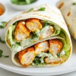 To make these wraps, you need a few key items: - 2 boneless, skinless chicken breasts - 2 tablespoons Cajun seasoning - 1 tablespoon olive oil - Salt and pepper to taste - 4 large flour tortillas - 2 cups Romaine lettuce, chopped - 1/2 cup Caesar dressing - 1/2 cup Parmesan cheese, grated These ingredients create a tasty mix. The chicken gets a spicy kick from the Cajun seasoning. The lettuce and cheese add crunch and creaminess. For the best flavor, use Cajun seasoning. It packs heat and depth. You should also add salt and pepper. These bring out the taste of the chicken. Feel free to adjust the seasoning to your liking. If you love spice, add more Cajun seasoning. You can enhance your wraps with a few extras: - 1/4 cup croutons, crushed (optional) - Fresh parsley, chopped for garnish Croutons add a nice crunch. They balance the soft chicken and salad. Chopped parsley makes the wraps look bright and fresh. These little touches can make a big difference! {{ingredient_image_1}} To start, you need to cook the chicken. First, preheat your grill or grill pan over medium-high heat. Grab your two boneless, skinless chicken breasts. Season them well with Cajun seasoning, salt, and pepper. Make sure to coat them evenly. Next, drizzle olive oil on the grill. Place the chicken on the grill and cook for about 6-7 minutes on each side. You want the chicken to be fully cooked and reach 165°F (75°C). After cooking, let the chicken rest for a few minutes. This helps keep it juicy. Now, slice the chicken into thin strips for easy wrapping. Now that your chicken is ready, it’s time to assemble the wraps. In a large bowl, mix 2 cups of chopped Romaine lettuce, 1/2 cup of Caesar dressing, and 1/2 cup of grated Parmesan cheese. Toss the mixture until the lettuce is well coated with dressing. Lay out your four large flour tortillas. In the center of each tortilla, evenly distribute the Caesar salad mixture. Top your salad with the sliced Cajun chicken. If you like, sprinkle crushed croutons on top for extra crunch. Now, roll up each tortilla tightly. Remember to fold in the sides as you go to create a neat wrap. Once finished, slice each wrap in half diagonally. Arrange them on a serving platter, and garnish with chopped parsley for a pop of color. These wraps make a great meal for lunch or dinner. Serve them with a side of fresh fruit or a light salad for a balanced meal. You can also pair them with extra Caesar dressing for dipping. This way, you can enjoy every bite! For a fun twist, try using different toppings, like avocado or sliced tomatoes. The options are endless! To cook chicken just right, start with good seasoning. I use Cajun seasoning, salt, and pepper. Coat the chicken breasts evenly. Heat your grill or pan to medium-high. Add a splash of olive oil to keep things from sticking. Place the chicken on the grill and cook for 6-7 minutes on each side. Use a meat thermometer to check for 165°F (75°C). Let the chicken rest before slicing. Resting keeps the juices inside. When wrapping, lay your tortilla flat. Place the filling in the center, leaving space at the edges. Start by folding in the sides. Next, roll the tortilla tightly from the bottom up. This helps keep all the tasty bits inside. If you want, you can use a toothpick to hold it together. It makes for neat serving and easy eating. To keep your wraps fresh, wrap them in plastic wrap or foil. This helps avoid sogginess. Store them in the fridge if you’re not eating them right away. For the best taste, eat them within a day. If you want to save them longer, consider freezing. Just remember to thaw them in the fridge before eating. This way, you enjoy that crispy texture. Pro Tips Marinating the Chicken: For an extra flavor boost, marinate the chicken in Cajun seasoning and olive oil for at least 30 minutes before grilling. Grill Marks: To achieve beautiful grill marks, avoid moving the chicken around too much while cooking. Let it sear before flipping. Fresh Ingredients: Using fresh Romaine lettuce and homemade croutons can elevate the taste of your wraps significantly. Wrap Tight: When rolling the tortillas, make sure to keep them tight and fold in the sides to prevent the filling from spilling out. {{image_2}} You can swap chicken for shrimp or tofu in this wrap. Shrimp adds a sweet taste. Just grill or sauté it with Cajun spices. Tofu is great for a plant-based meal. Press and cube the tofu, then marinate it in the Cajun seasoning. Cook until golden, and it will soak up all that flavor. For a vegetarian wrap, use grilled vegetables instead of meat. Bell peppers, zucchini, and mushrooms work well. Just toss them in olive oil and Cajun seasoning before grilling. If you want a vegan option, skip the Caesar dressing and cheese. Use a vegan mayo or tahini dressing instead. It keeps everything creamy and delicious. You can play with different spices to change the flavor. If you like heat, add more cayenne pepper. For a smoky taste, try smoked paprika. You can also mix in Italian herbs for a twist. Experimenting with spices makes your wraps exciting and personal. Don't be afraid to get creative! To store leftover Cajun Chicken Caesar wraps, keep them in an airtight container. This helps to keep the wraps fresh. You can also wrap them in plastic wrap. Make sure to place the wraps in the fridge. They stay good for about 2 to 3 days. If you notice any sogginess, use a paper towel to help absorb extra moisture. If you want to save wraps for later, freezing is a great option. First, wrap each wrap tightly in plastic wrap. Then, place the wrapped wraps in a freezer bag. Squeeze out as much air as you can to avoid freezer burn. They can last up to 2 months in the freezer. When you are ready to enjoy, thaw them in the fridge overnight before reheating. Reheating your Cajun Chicken Caesar wraps can bring back their great taste. You can use a microwave for quick reheating. Place a wrap on a microwave-safe plate and cover it with a damp paper towel. Heat it for about 30 seconds. For a crispier wrap, use an oven or a stovetop. Place the wrap in a preheated oven at 350°F for about 10 minutes. If using a skillet, heat it on medium for about 3-4 minutes on each side. This keeps the wrap warm and crispy. Cajun Chicken Caesar Wraps mix Cajun food from Louisiana with classic Caesar salad. Cajun food comes from early French settlers. They used local spices and ingredients. The Caesar salad started in Mexico but grew in the U.S. This wrap combines bold flavors and fresh veggies. It's a tasty twist on two beloved dishes. Yes, you can make the wraps ahead of time. Prepare the chicken and salad mix. Store them separately in the fridge. When ready to eat, assemble the wraps. This keeps the tortillas fresh and crisp. You can also wrap them tightly in foil. Just be sure to eat them within one day for the best taste. You can use ranch dressing instead of Caesar dressing. It offers a creamy taste that works well. Other good options are blue cheese dressing or yogurt dressing. You might also try a vinaigrette for a lighter flavor. Each choice will give the wrap a unique twist. Cajun Chicken Caesar Wraps blend bold flavors and fresh ingredients. We explored main ingredients, seasonings, and optional toppings that enhance taste. The step-by-step guide showed how to prepare chicken, assemble wraps, and serve them well. We shared tips for cooking chicken, wrapping effectively, and keeping your wraps fresh. Variations offered exciting protein choices and ways to cater to diets. Lastly, storage info covered how to keep and reheat your wraps. Enjoy making these wraps your own, and share the deliciousness with others!