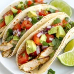 - 2 boneless, skinless chicken breasts - 1/4 cup olive oil - Juice of 2 limes - Zest of 1 lime The main ingredients set the stage for the bold flavors in these tacos. The chicken is tender and juicy, making it the perfect base. The olive oil adds richness, while lime juice and zest bring a bright kick. The fresh taste of lime makes each bite refreshing. - 1 teaspoon ground cumin - 1 teaspoon smoked paprika - 1 teaspoon garlic powder - Salt and pepper to taste Spices are key to great flavor. Ground cumin adds warmth and depth. Smoked paprika gives a subtle smokiness. Garlic powder enhances the taste with its savory notes. Salt and pepper finish the mix, bringing all the flavors together. - 1 cup fresh cilantro, chopped - Corn or flour tortillas - 1 cup diced tomatoes - 1 avocado, sliced - 1/2 cup red onion, finely chopped - 1 jalapeño, sliced (optional) - Lime wedges, for serving Toppings make these tacos pop! Fresh cilantro adds a burst of green flavor. Choose corn or flour tortillas based on your preference. Diced tomatoes and avocado add creaminess and freshness. Red onion gives a bit of crunch, while jalapeño offers heat for those who like it spicy. Lime wedges are a must for that extra zing. With these ingredients, you can create tacos that are not only tasty but also visually stunning. The variety of colors and textures will impress anyone you serve. - In a small bowl, whisk together: - 1/4 cup olive oil - Juice of 2 limes - Zest of 1 lime - 1 teaspoon ground cumin - 1 teaspoon smoked paprika - 1 teaspoon garlic powder - Salt and pepper to taste Mix until well blended. This marinade brings a bright flavor to the chicken. - Place the chicken breasts in a resealable bag or dish. Pour the marinade over the chicken. Seal the bag or cover the dish. Marinate in the refrigerator for at least 30 minutes. For more taste, marinate up to 2 hours. - Preheat your grill or skillet over medium-high heat. This step ensures a nice sear. - Remove the chicken from the marinade. Cook the chicken for 6-7 minutes on each side. It is done when the internal temperature reaches 165°F. The chicken should look golden brown and juicy. - After cooking, let the chicken rest for a few minutes. This keeps it tender. Slice it into thin strips. - Warm the tortillas on the grill or in a dry skillet for about 30 seconds on each side. This makes them soft and easy to fold. - Assemble the tacos: Place a few strips of chicken on each tortilla. Then, add toppings like: - 1 cup diced tomatoes - 1 avocado, sliced - 1/2 cup red onion, finely chopped - 1 jalapeño, sliced (optional) - 1 cup fresh cilantro, chopped - Serve the tacos with lime wedges on the side. The lime adds a zesty kick that brightens each bite. To boost the flavor of your chicken, marinate it well. This helps the chicken soak up all the tasty spices and lime juice. I suggest a marinating time of at least 30 minutes. However, if you have the time, go for 2 hours. This longer soak makes the chicken even more delicious. If you don’t want to grill, a skillet works great too. You can also bake the chicken in the oven. Just make sure the chicken reaches an internal temperature of 165°F (75°C). This means it’s safe to eat. To check for doneness, cut into the thickest part of the chicken. If the juices run clear, you’re good to go! Make your tacos pop with some fun serving ideas. Arrange them on a colorful plate or a rustic wooden board. It adds a nice touch to your meal. For garnishing, sprinkle extra cilantro on top. Squeeze some lime juice over the tacos. This gives them a fresh look and taste. {{image_2}} For a fun twist, swap chicken for shrimp or tofu. Shrimp cooks fast and adds a nice texture. Tofu provides a great vegetarian option. Both choices work well with the marinade. You can also change up the tortillas. Try whole wheat tortillas for a healthier option. Lettuce wraps are great for a lighter meal. They add a fresh crunch that everyone will enjoy. Want to kick up the flavor? Add more spices like chili powder or cayenne pepper. Hot sauces can bring the heat and excite the taste. Just a few drops can change everything. Incorporating seasonal veggies can also enhance your tacos. Bell peppers and corn add color and crunch. Zucchini or summer squash blends well with the chicken too. Use what is fresh and local! Pair your tacos with sides like rice or beans for a full meal. Cilantro-lime rice complements the tacos well. You can also serve black beans for extra protein and flavor. For drinks, try a light beer or a fruity soda. A refreshing margarita or a limeade can elevate your meal. Choose drinks that balance the flavors of the tacos. To keep your cooked chicken fresh, place it in an airtight container. Store it in the fridge for up to four days. If you have assembled tacos, it's best to keep them separate. This helps prevent soggy tortillas. Store tortillas in a sealed bag and toppings in separate containers. For safe reheating, use a microwave or skillet. Heat chicken until it reaches 165°F again. For tortillas, warm them in a dry skillet. This makes them soft and pliable. Reheat tortillas for about 30 seconds on each side. Enjoy them within two days for the best taste. To freeze chicken, let it cool completely first. Place it in a freezer bag and squeeze out the air. It can last up to three months. For toppings, you can freeze diced tomatoes and chopped cilantro, too. To thaw, place them in the fridge overnight. Reheat chicken in a skillet for the best flavor. To know if the chicken is done, use a meat thermometer. Insert it into the thickest part of the chicken. It should read 165°F (75°C). You can also check the color. The meat should be white, with no pink inside. Juices should run clear. Both methods ensure your chicken is safe to eat. You can prep these tacos in advance. Marinate the chicken a day before. Store it in the fridge. This will make the flavors deeper. Cooked chicken can be stored for up to four days. Keep it in an airtight container. Warm it up when you’re ready to eat. You can also chop toppings ahead of time. Just store them in separate containers. This way, you can assemble the tacos quickly. If you need a substitute for lime juice, try lemon juice. It has a similar tangy flavor. You can also use vinegar, like apple cider vinegar. This will give a different taste but still work well. Another option is to use orange juice. It adds sweetness but may change the flavor slightly. Each substitute will keep your tacos tasty. Cilantro lime chicken tacos are simple and tasty. You learned about the main ingredients, marinating, and cooking steps. I shared tips for perfect flavor and creative serving ideas. You can swap ingredients, enhance flavors, or store leftovers easily. Enjoy making these tacos at home and impressing your friends. Use the ideas shared to personalize your dish. You’ll experience the fresh taste and enjoy every bite. Try it today!